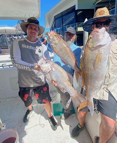 Three Men Holding Large Fish They Caught | Fishing Charters Sunshine Coast 