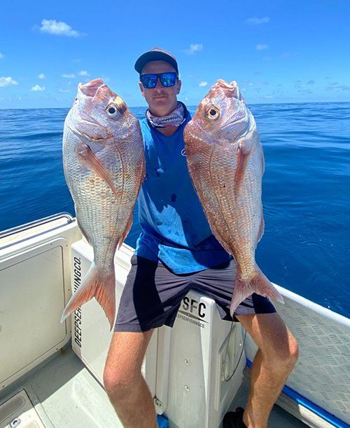 Man Holding 2 Snapper Fish on the Yacht | Fishing Charters Sunshine Coast