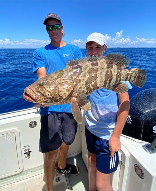 Happy Kid Holding Large Cod Fish He Caught | Fishing Charters Sunshine Coast