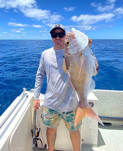 Guy Caught & Holding Fresh Goldband Snapper | Fishing Charters Sunshine Coast
