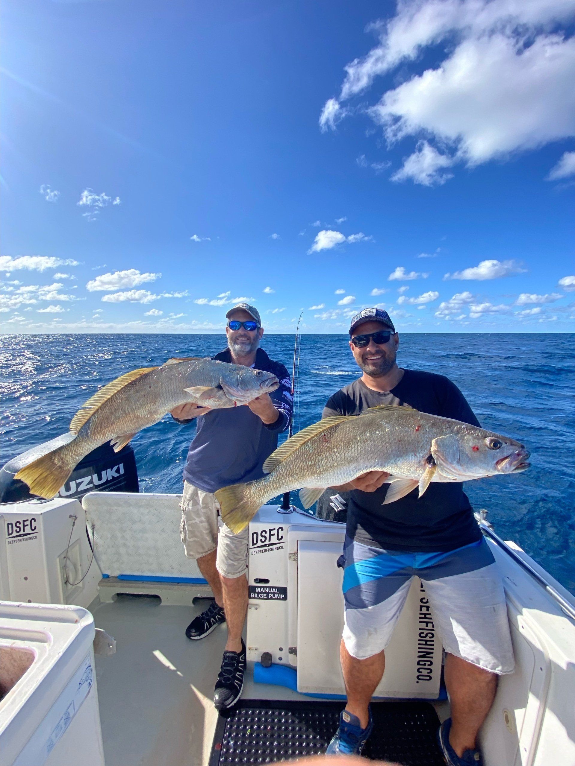 Two guys holding fishes - Fishing Charters Sunshine Coast