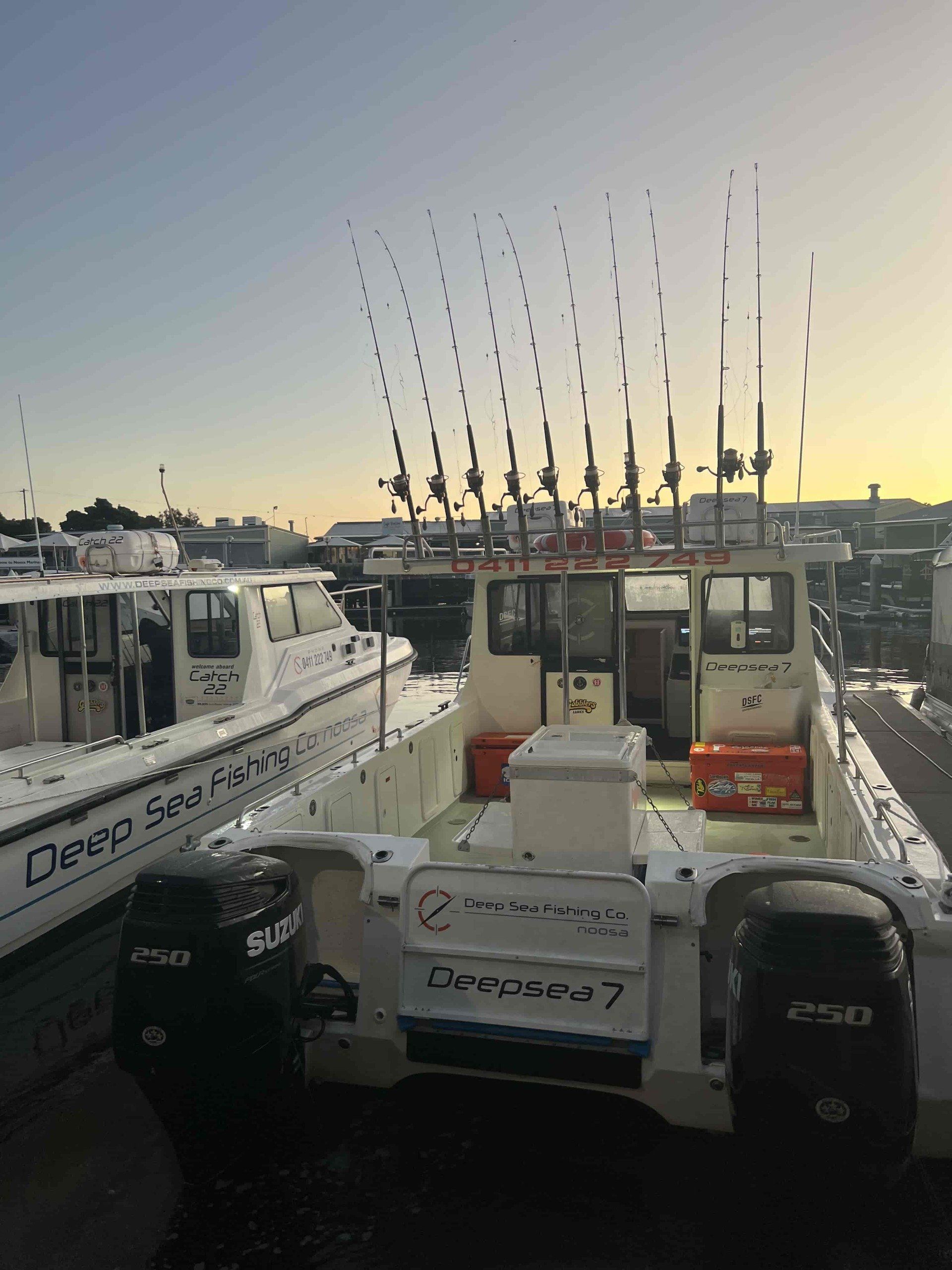 A couple of boats are parked next to each other in a marina.