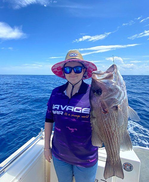 Lady Wearing Sunglasses while Holding Large Fish | Fishing Charters Sunshine Coast QLD
