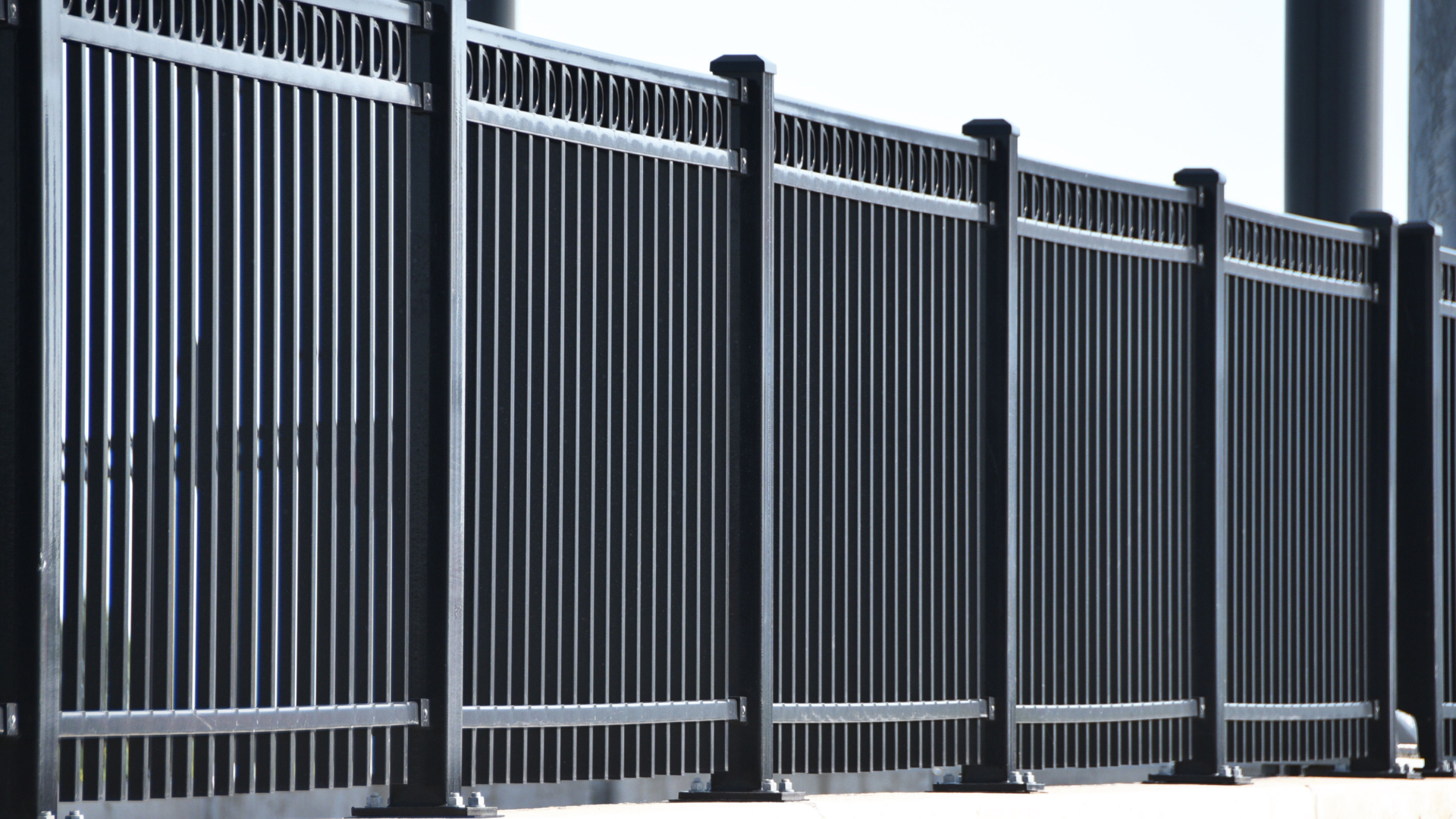 Black metal fence with vertical bars.