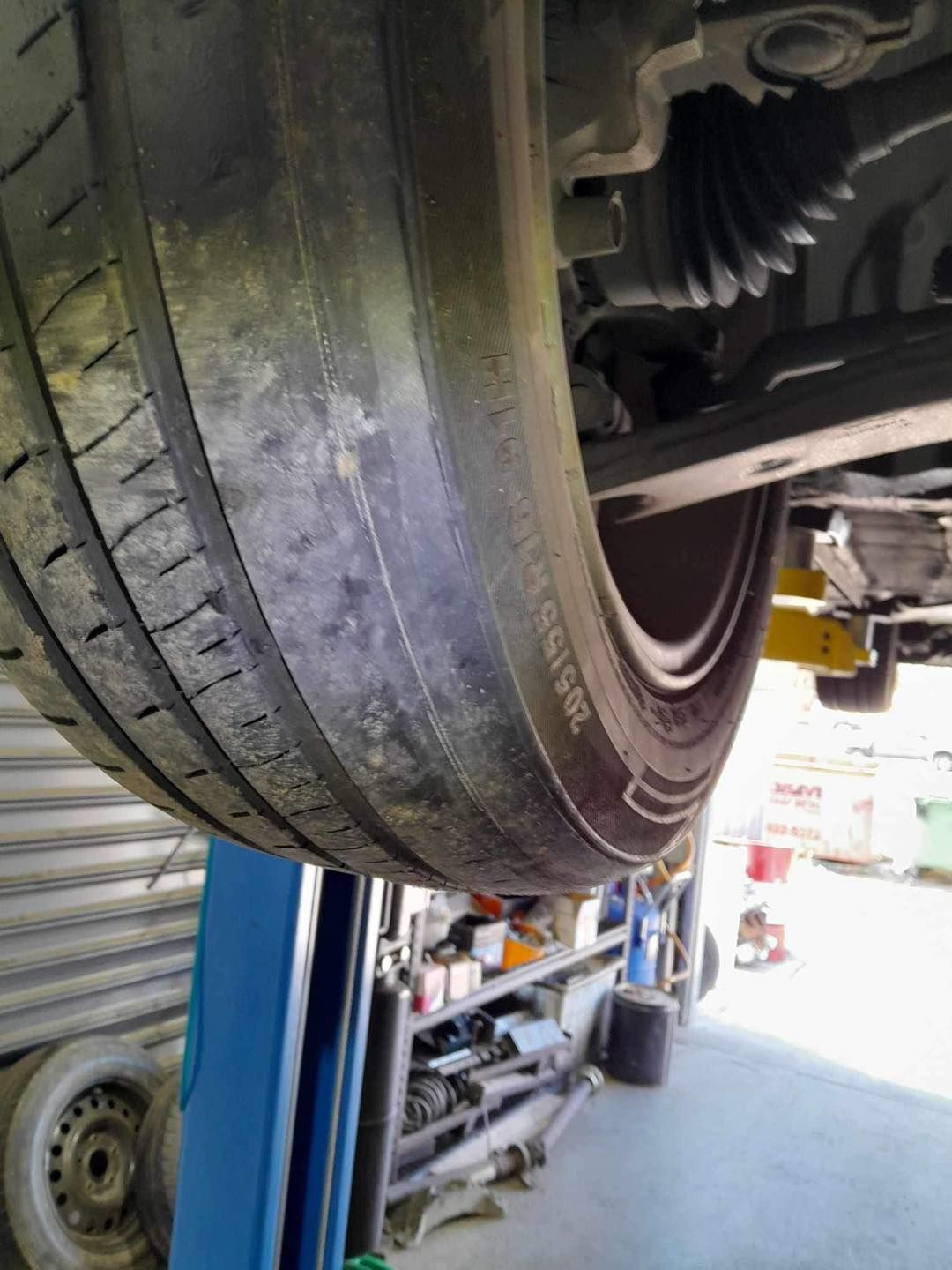 A Close Up of a Tire on a Lift in a Garage — Gricey's Workshop Automotive Specialist in West Wodonga, VIC