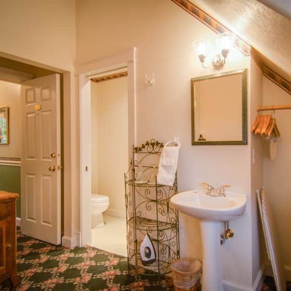 A bathroom with a sink , toilet and mirror.