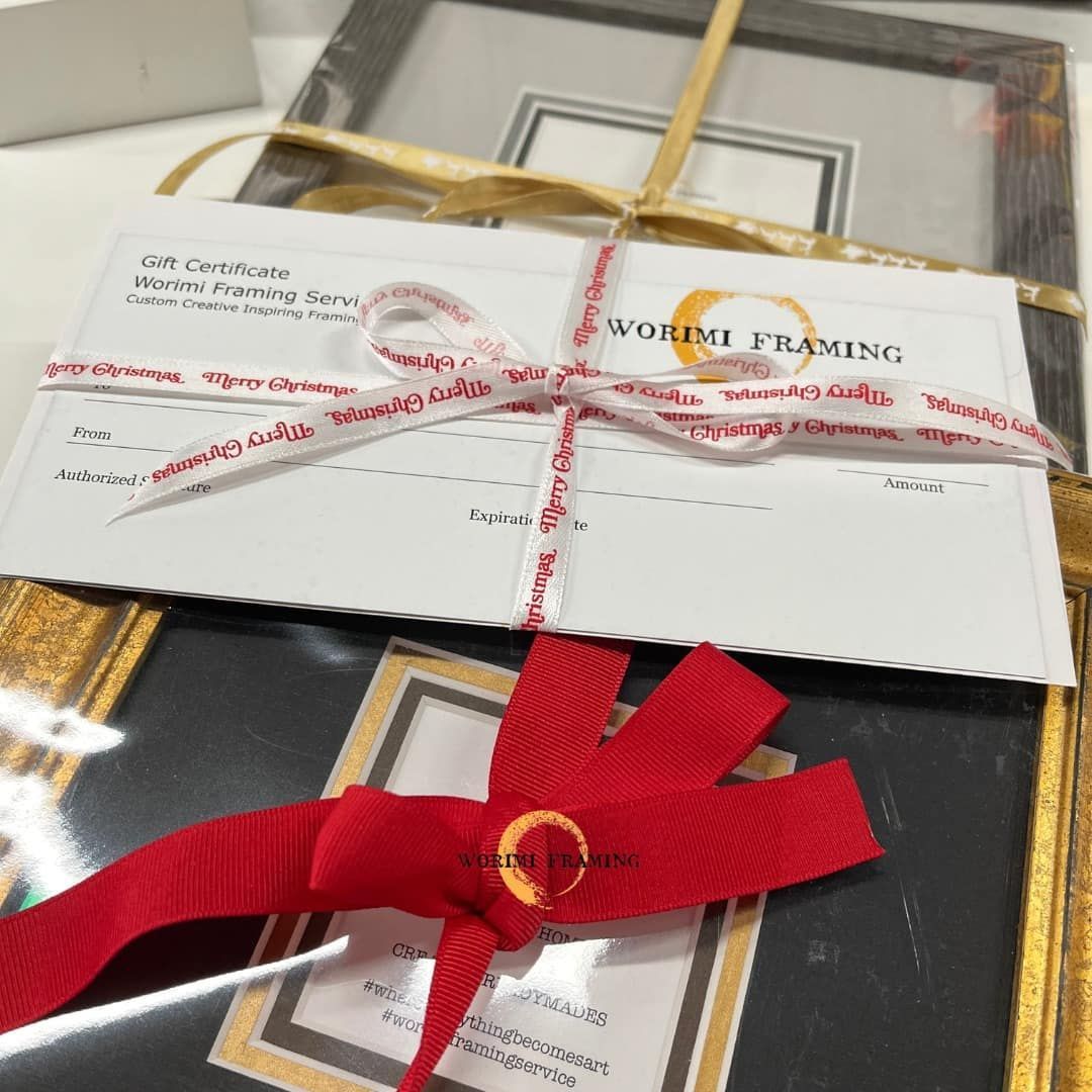 A Picture Frame With A Red Ribbon Tied Around It — Worimi Framing Service In Maitland, NSW
