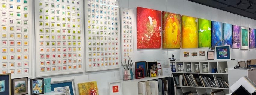 Framed Paintings On A Wall With A Bookshelf — Worimi Framing Service In Adamstown, NSW