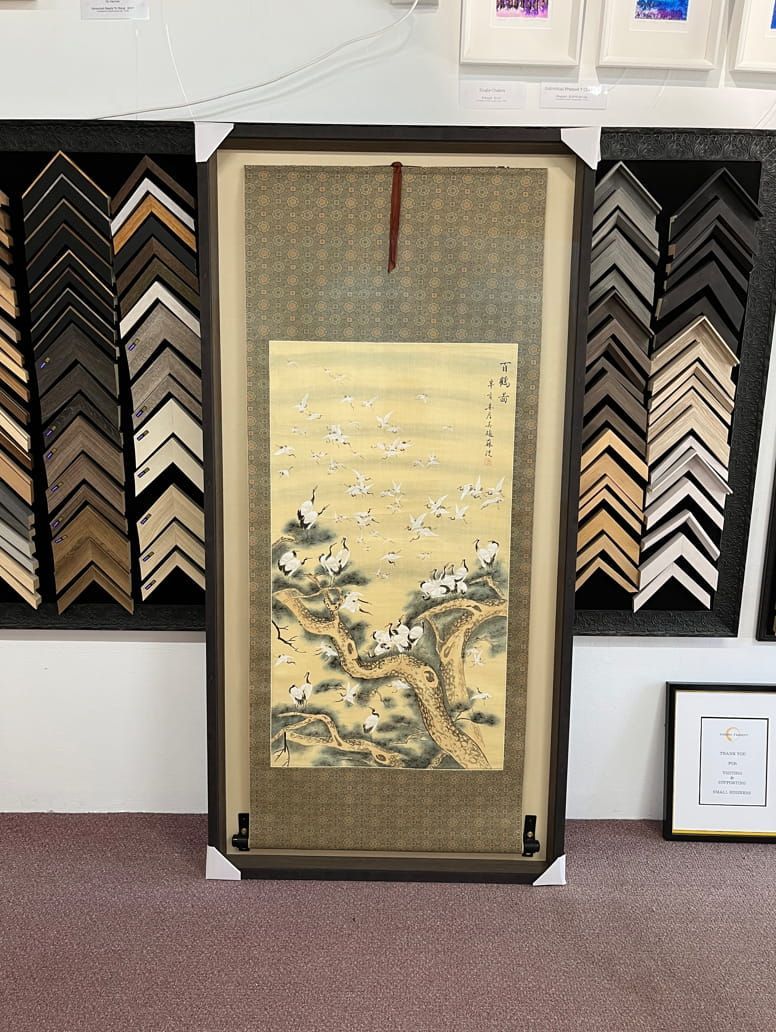 A Framed Painting Is Hanging On A Wall In A Room — Worimi Framing Service In Newcastle, NSW