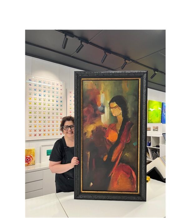 A Woman Holding A Framed Painting — Worimi Framing Service In Adamstown, NSW