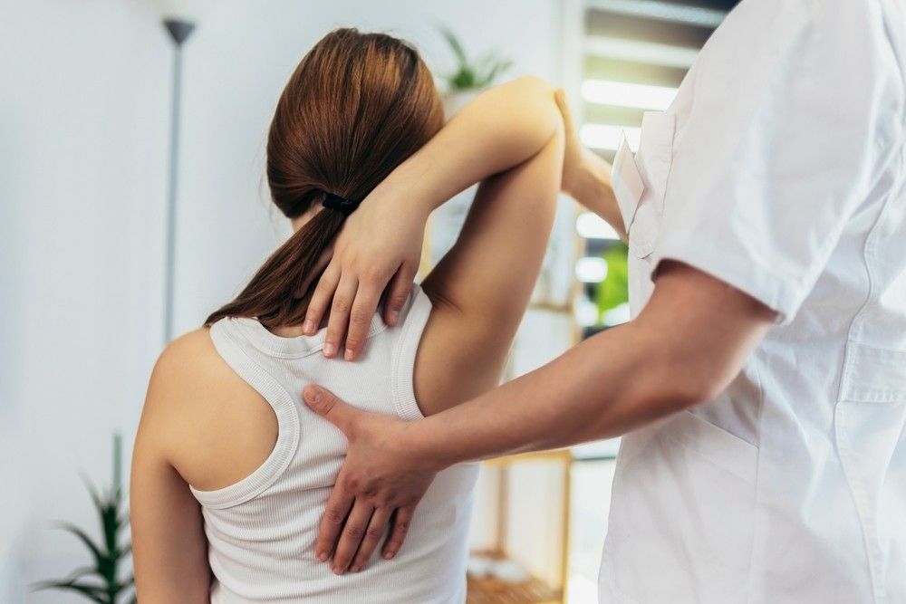 A Woman is Having a Massage From a Doctor — Mark O'Brien Chiropractic in West End, QLD