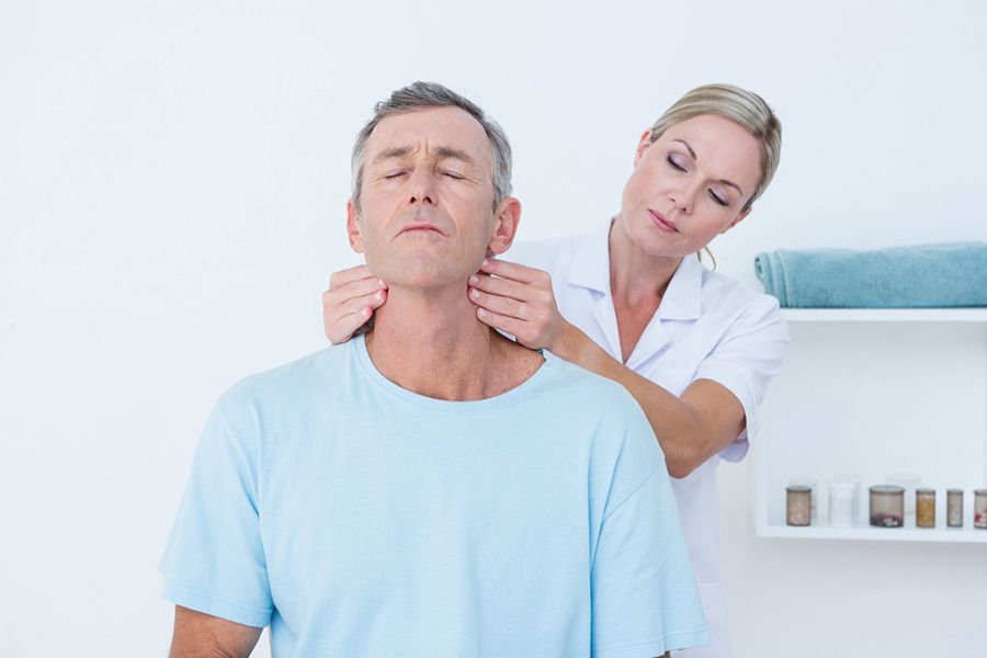 A Woman is Giving a Man a Neck Massage — Mark O'Brien Chiropractic in West End, QLD