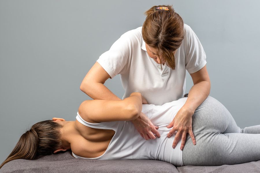 A wOman is Laying on a Table Getting a Massage From a Doctor — Mark O'Brien Chiropractic in West End, QLD