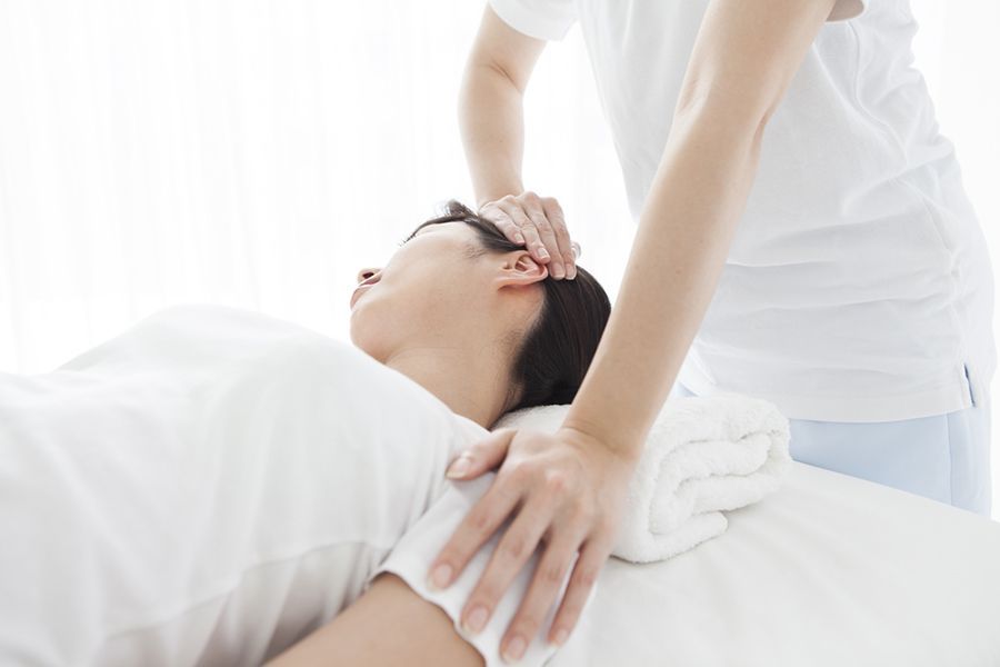 A Woman is Giving a Massage on a Bed — Mark O'Brien Chiropractic in West End, QLD