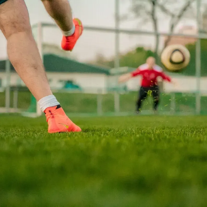 A Person is Kicking a Soccer Ball on a Field — Mark O'Brien Chiropractic in West End, QLD