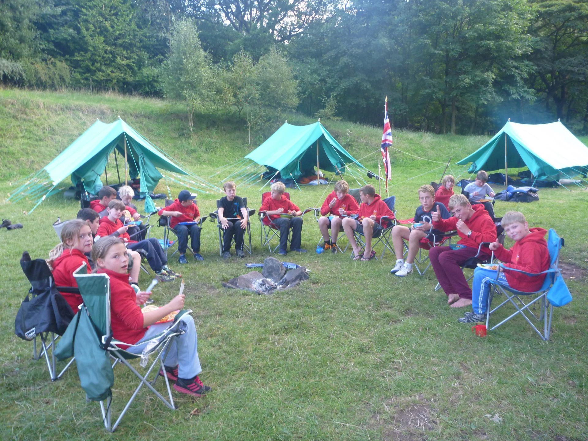A group of people are sitting around a campfire