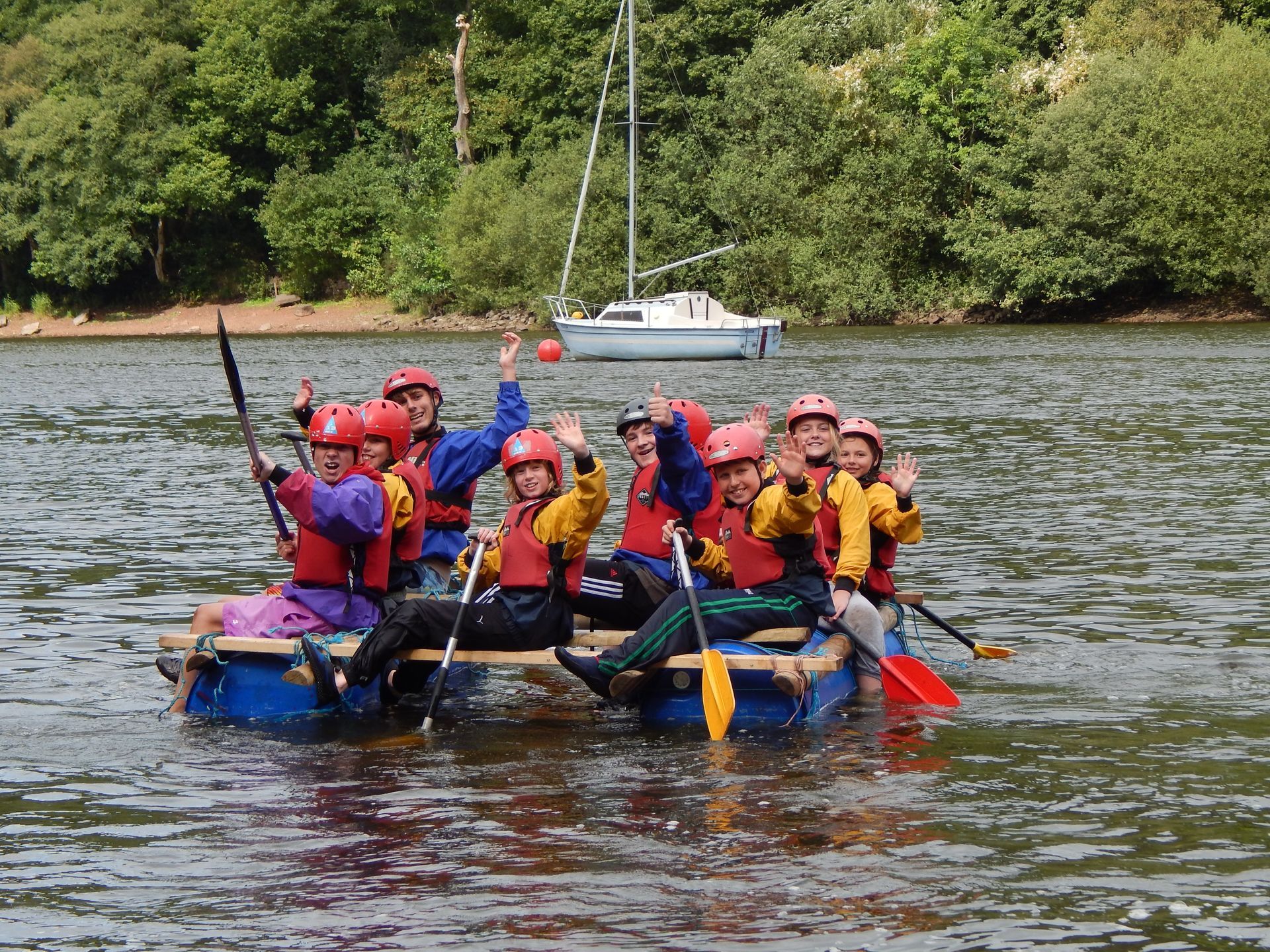 A group of people are sitting on a raft in the water