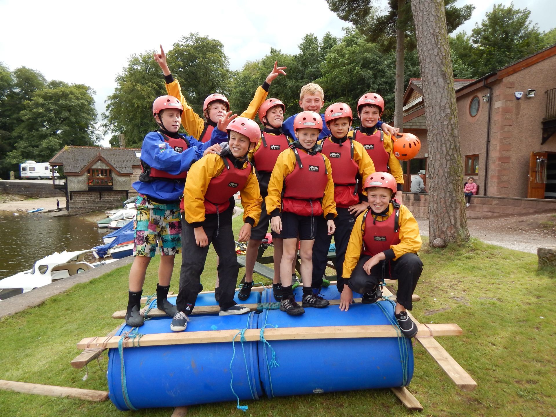 A group of young boys are posing for a picture on a blue raft.