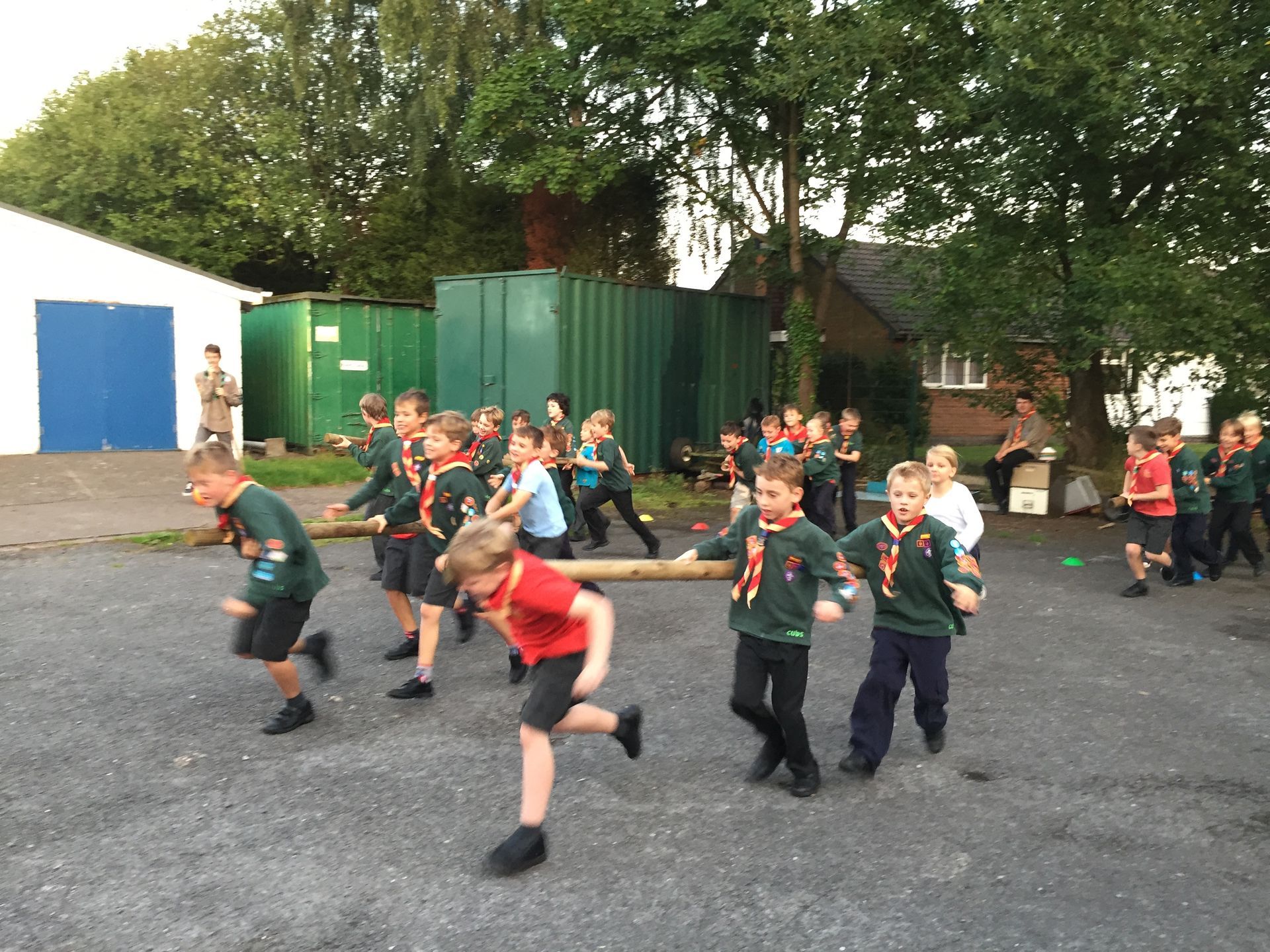 A group of young boys are playing a game in a parking lot