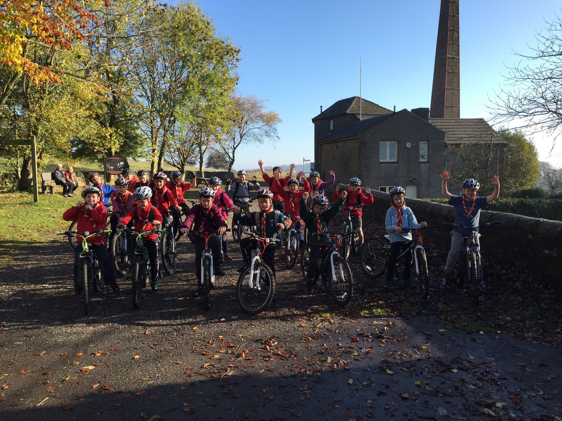 A group of people are riding bikes in front of a building.