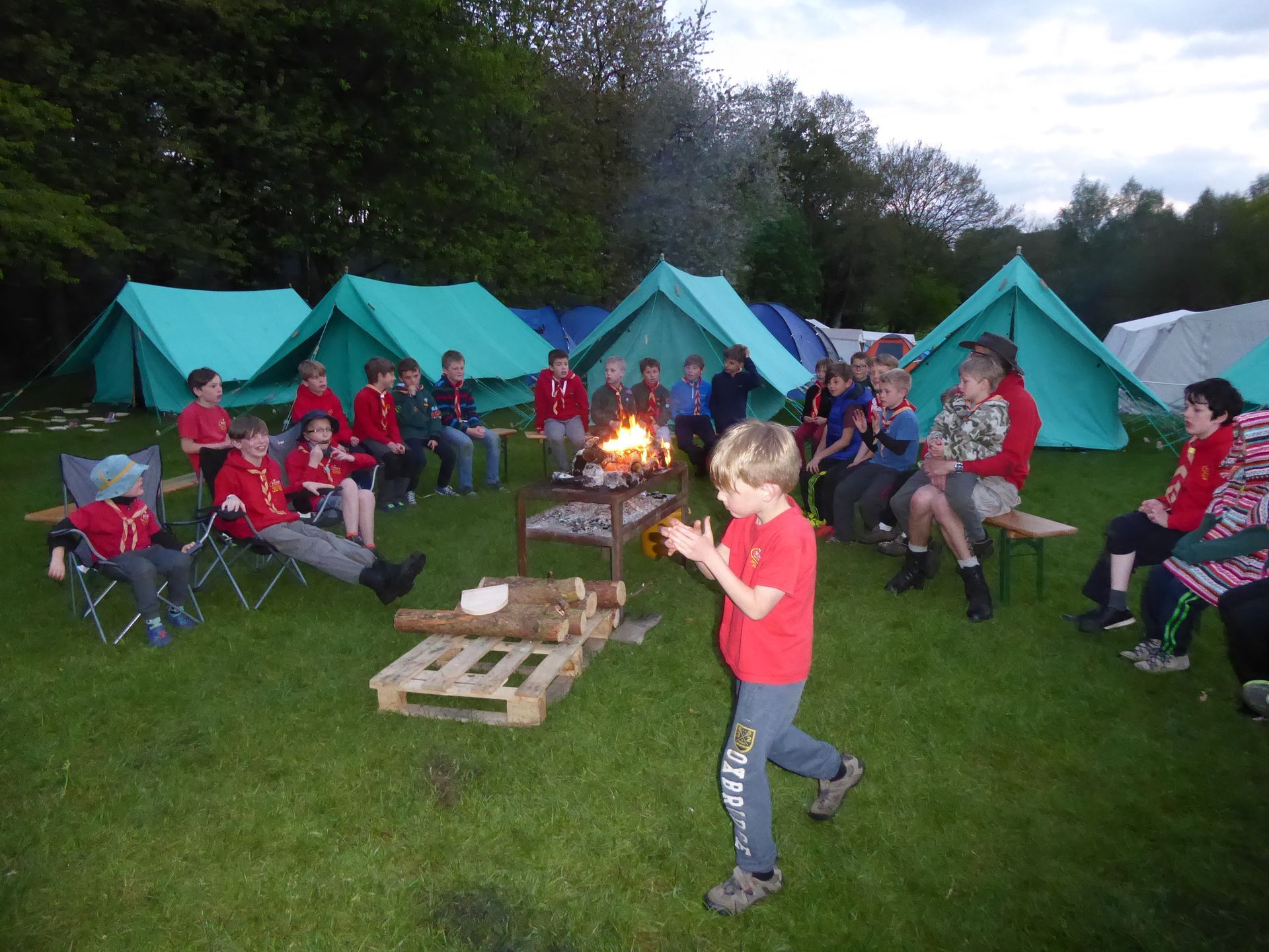 A group of people are sitting around a campfire