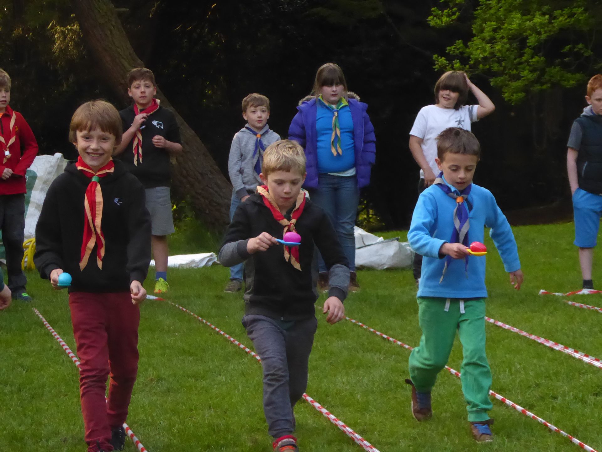 A group of young boys are playing a game in the grass