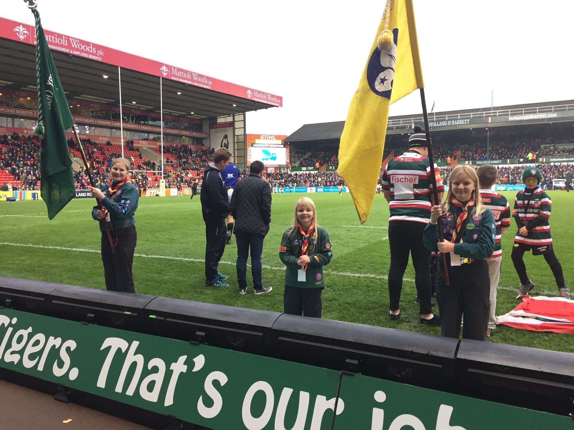 A group of people standing in front of a sign that says that 's our job