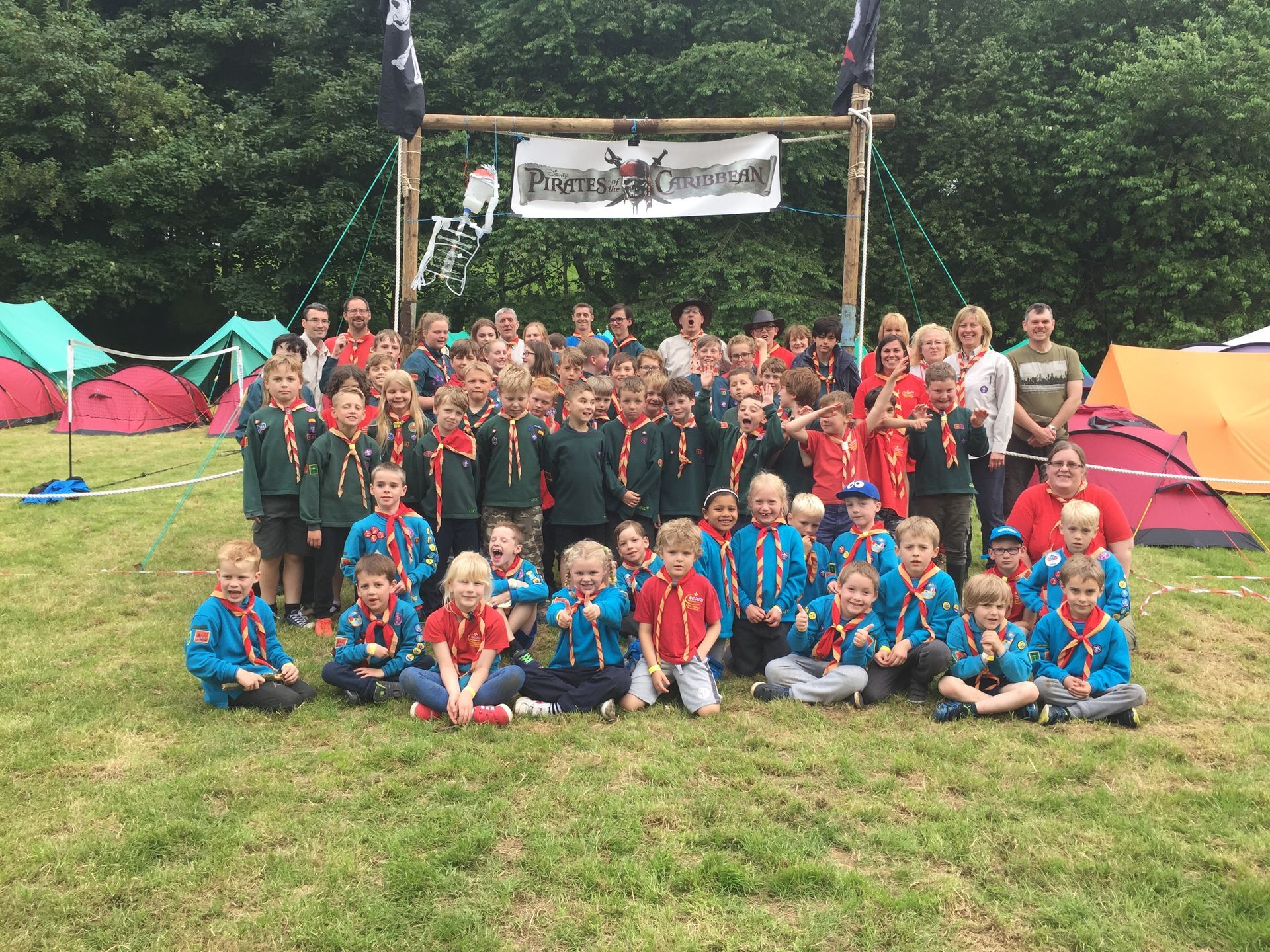 A group of children are posing for a picture in a field.