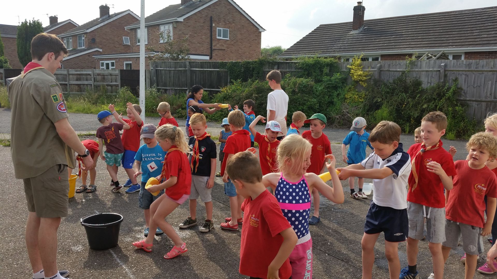 A group of children are playing with water balloons outside