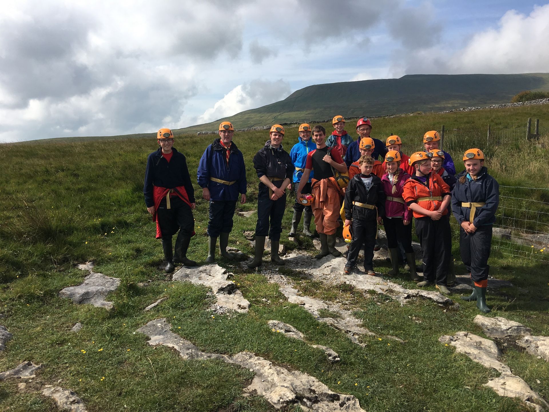 A group of children are posing for a picture in a field.