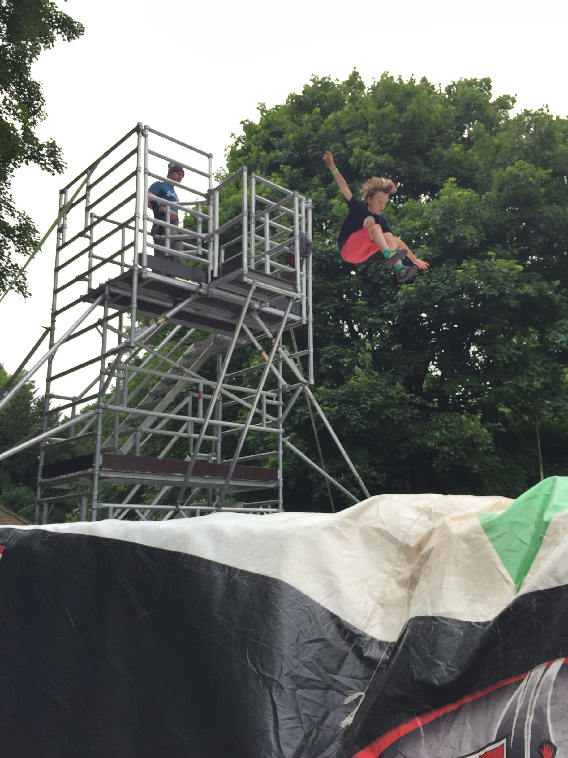 A person is doing a trick on a skateboard in the air