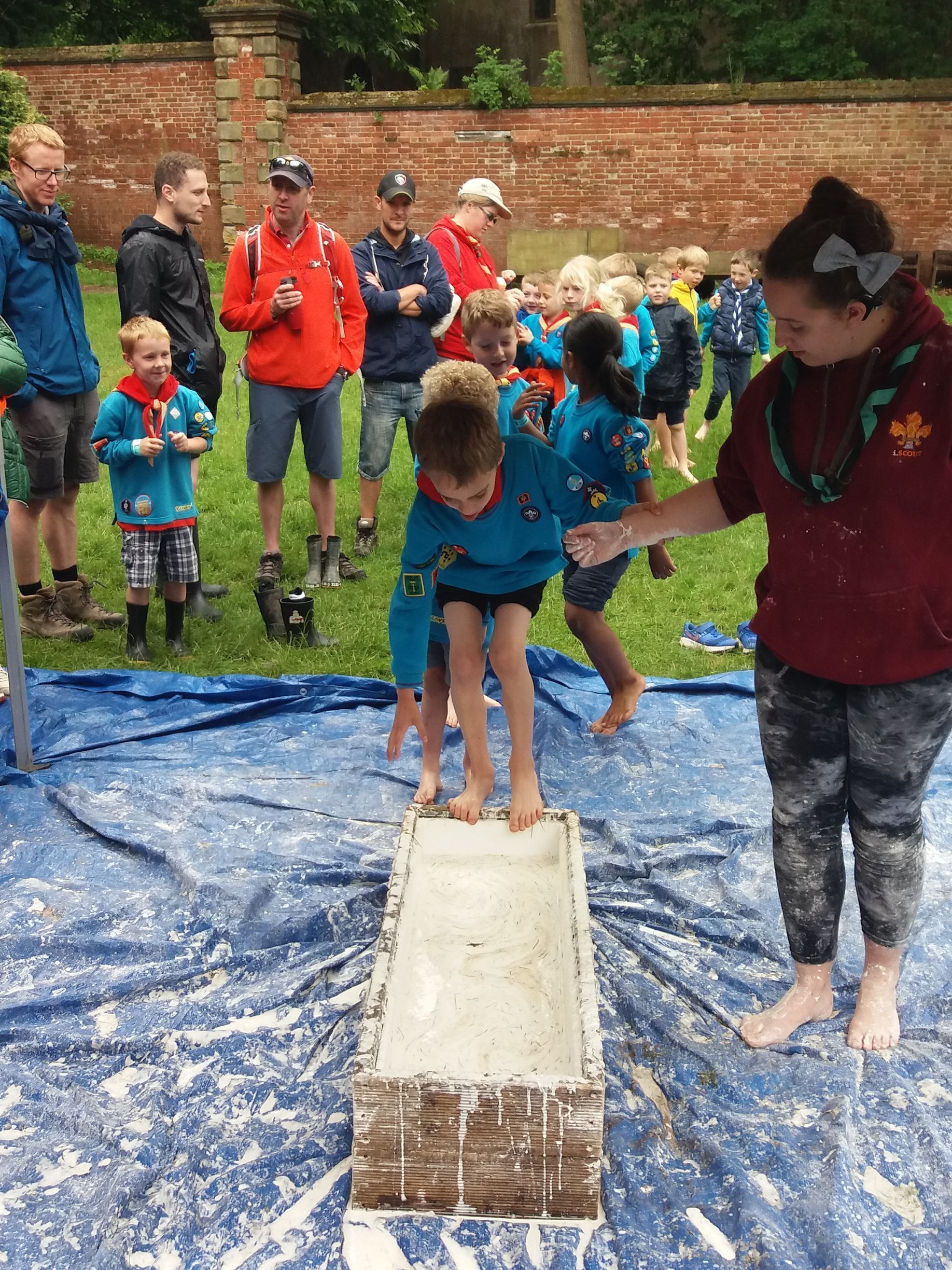A group of children are playing a game in a field.