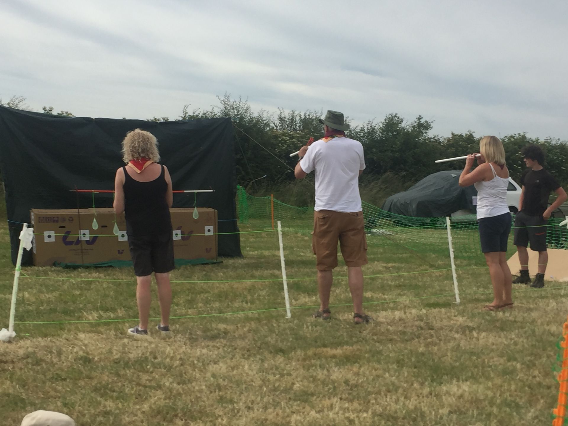 A group of people are playing a game in a field.