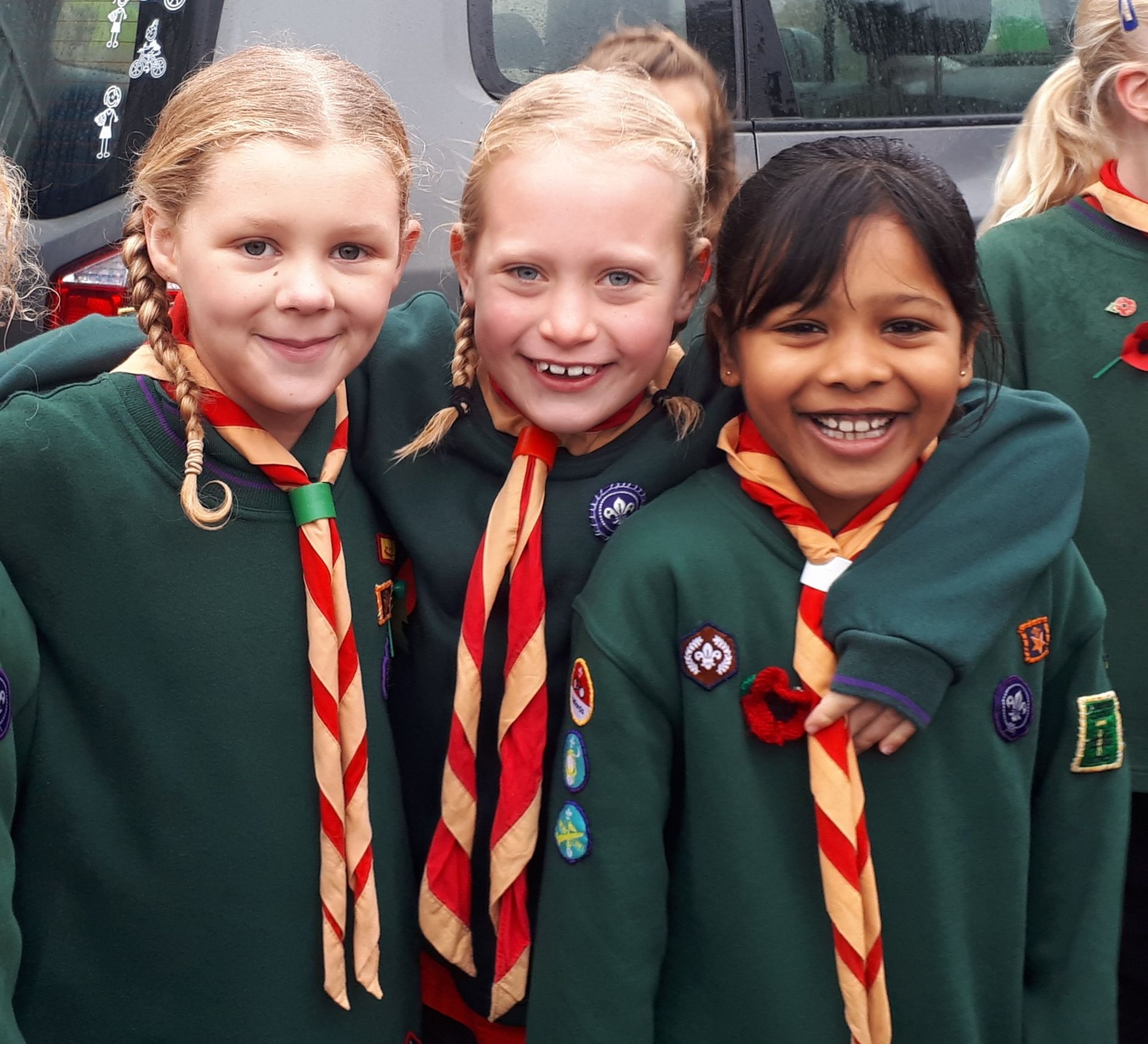 A group of girl scouts are posing for a picture