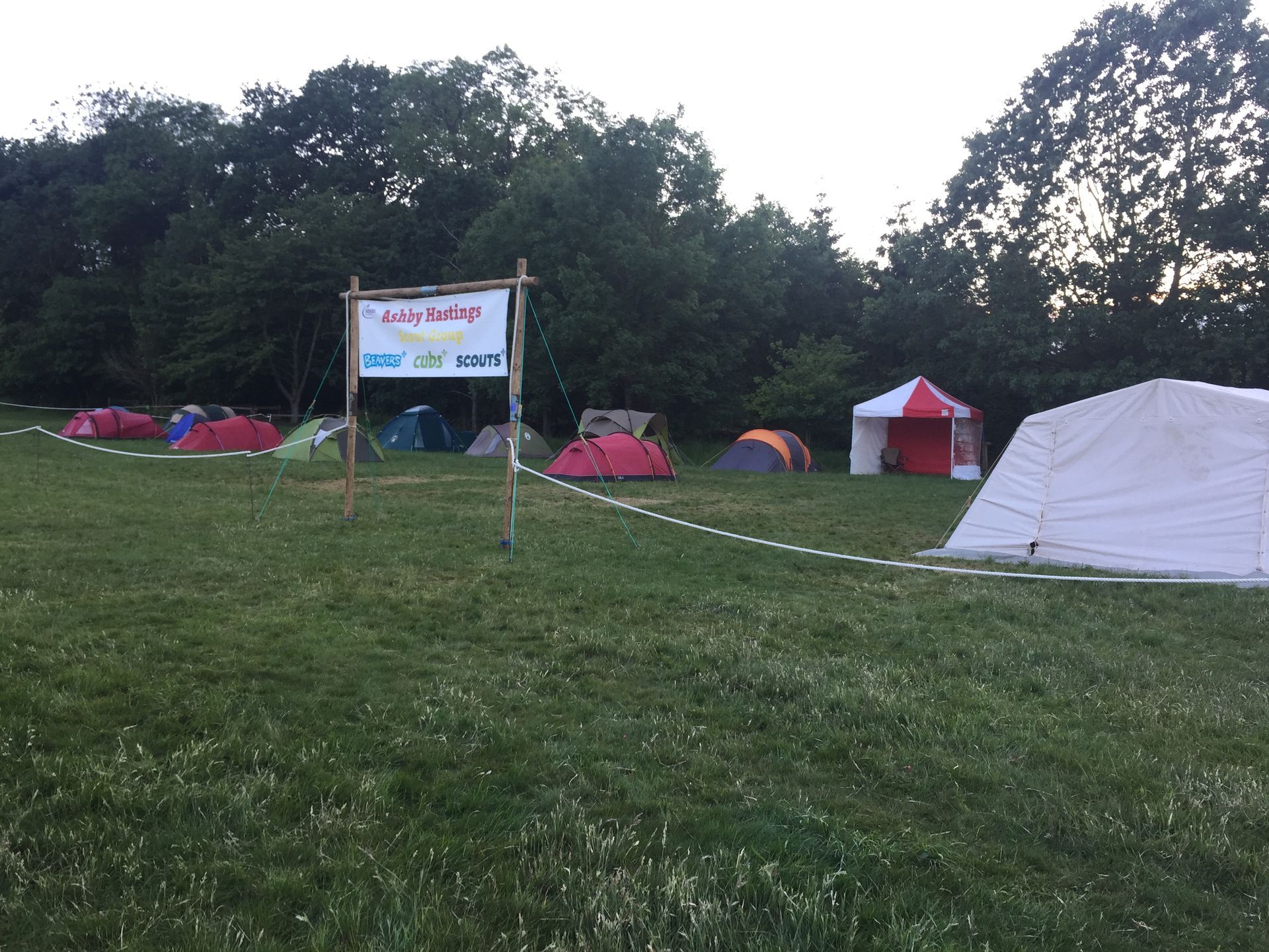 A group of tents are sitting in a grassy field.