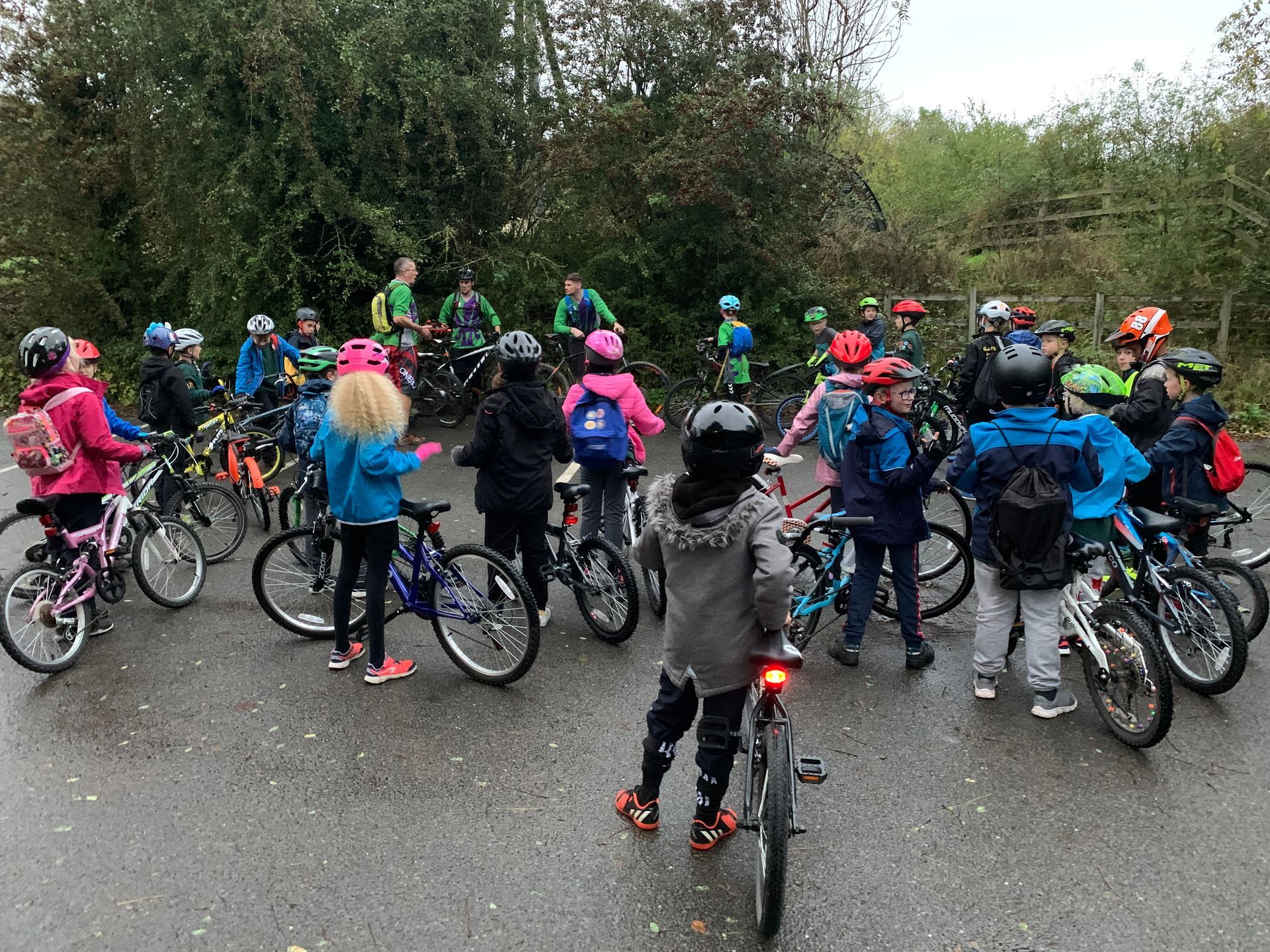 A group of children are riding bicycles down a road.