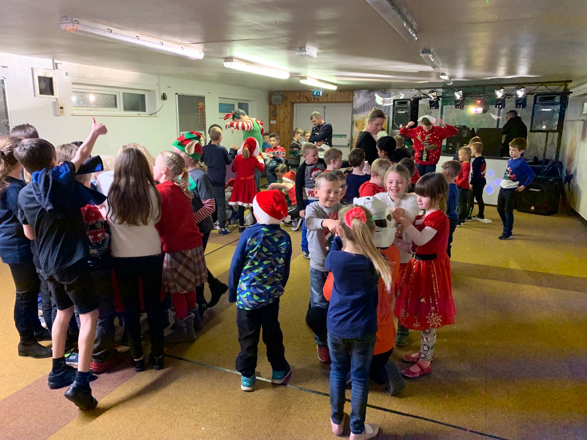 A group of children are standing in a room.
