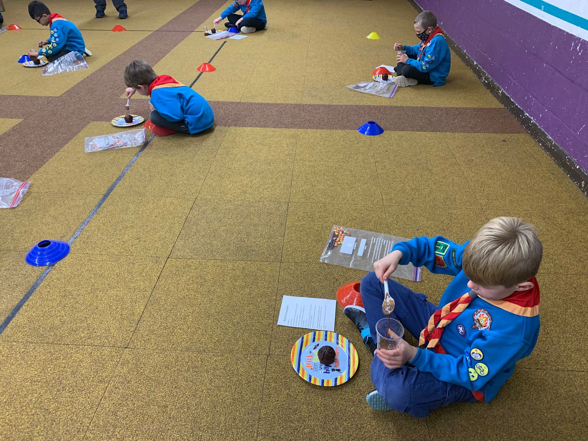 A group of children are sitting on the floor playing with toys.