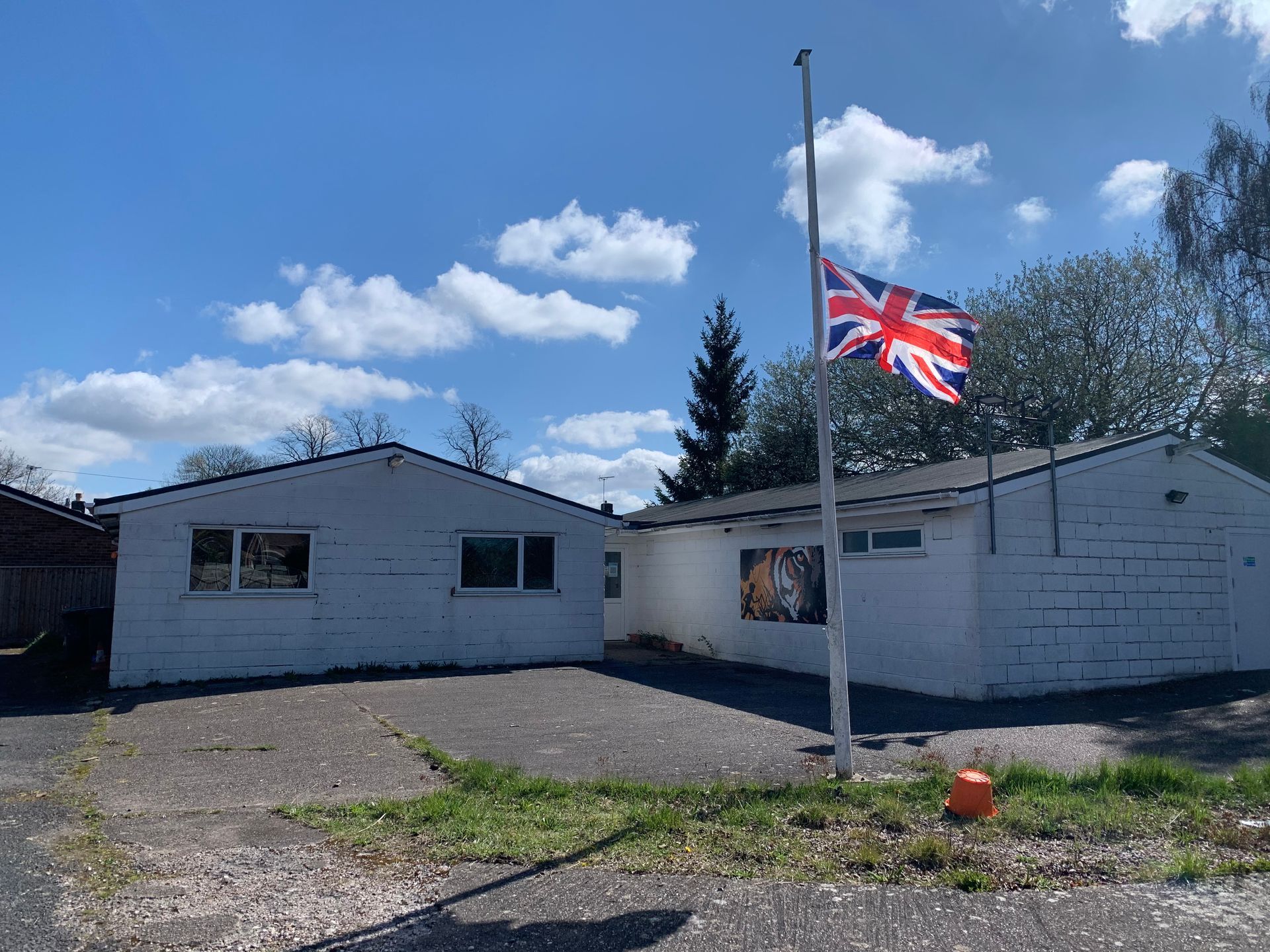 A british flag is flying in front of a white house