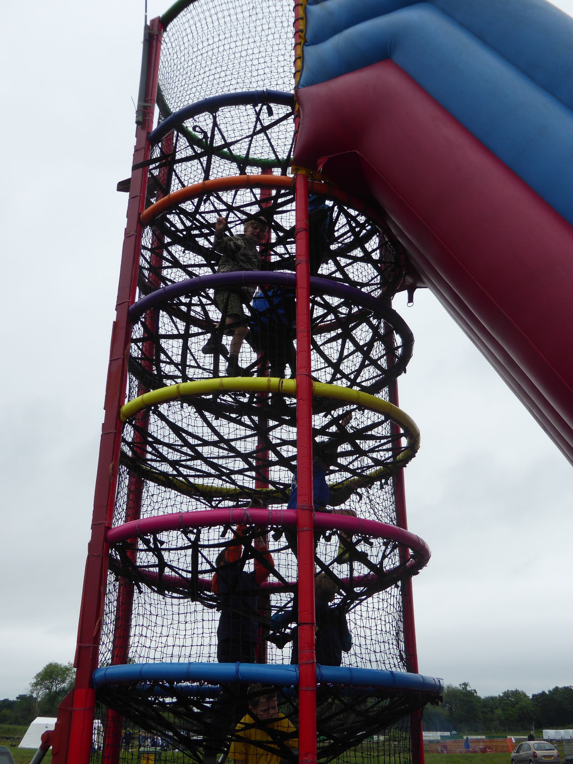 A group of children are playing on a climbing net