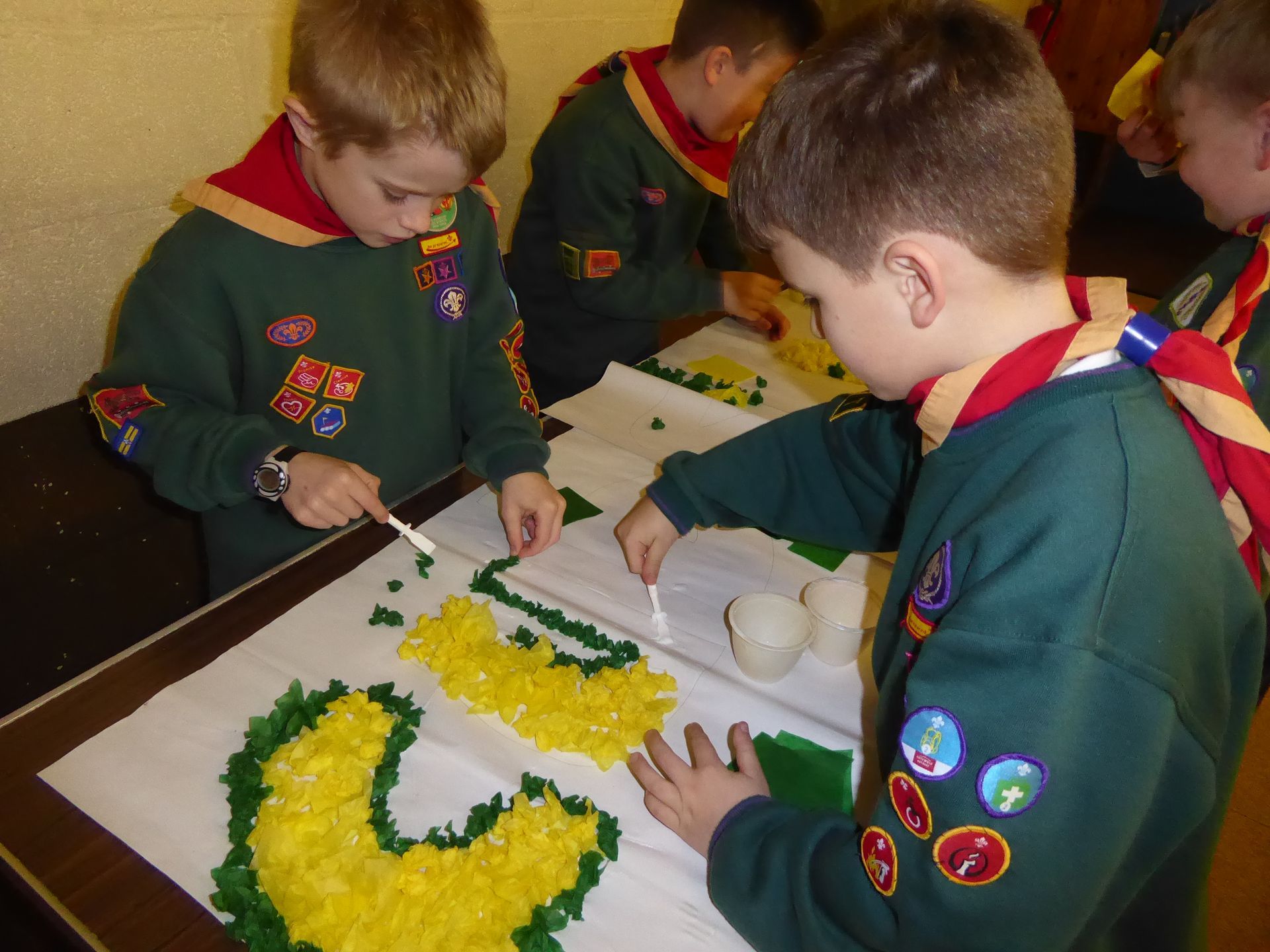 A group of boy scouts are working on a project