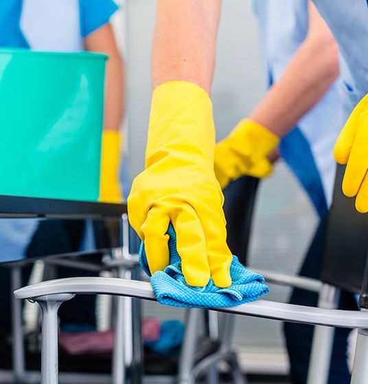 Person In Yellow Gloves Cleaning commercial office chair in Darwin