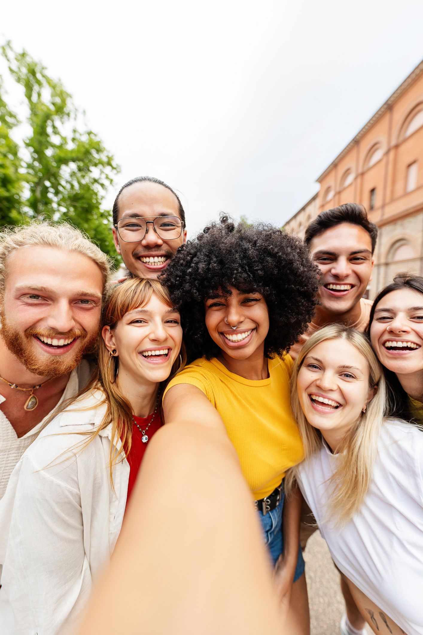 A group of young people are taking a selfie together.