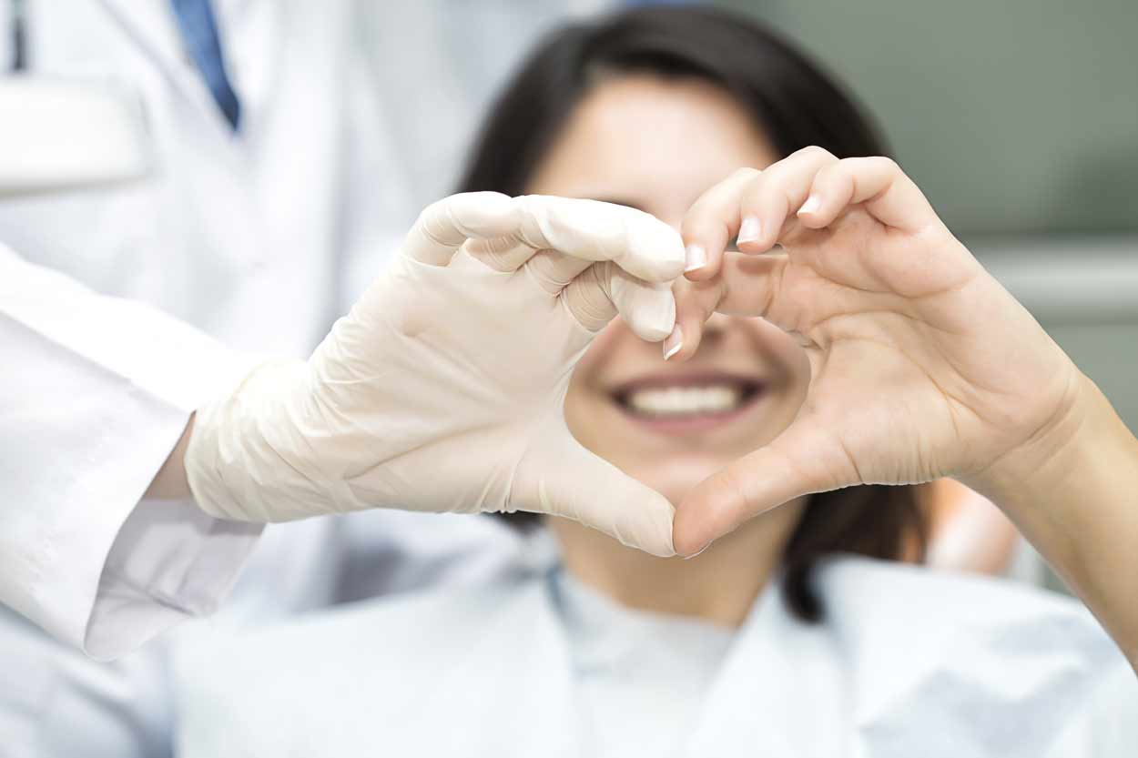 Dentist making heart with hands