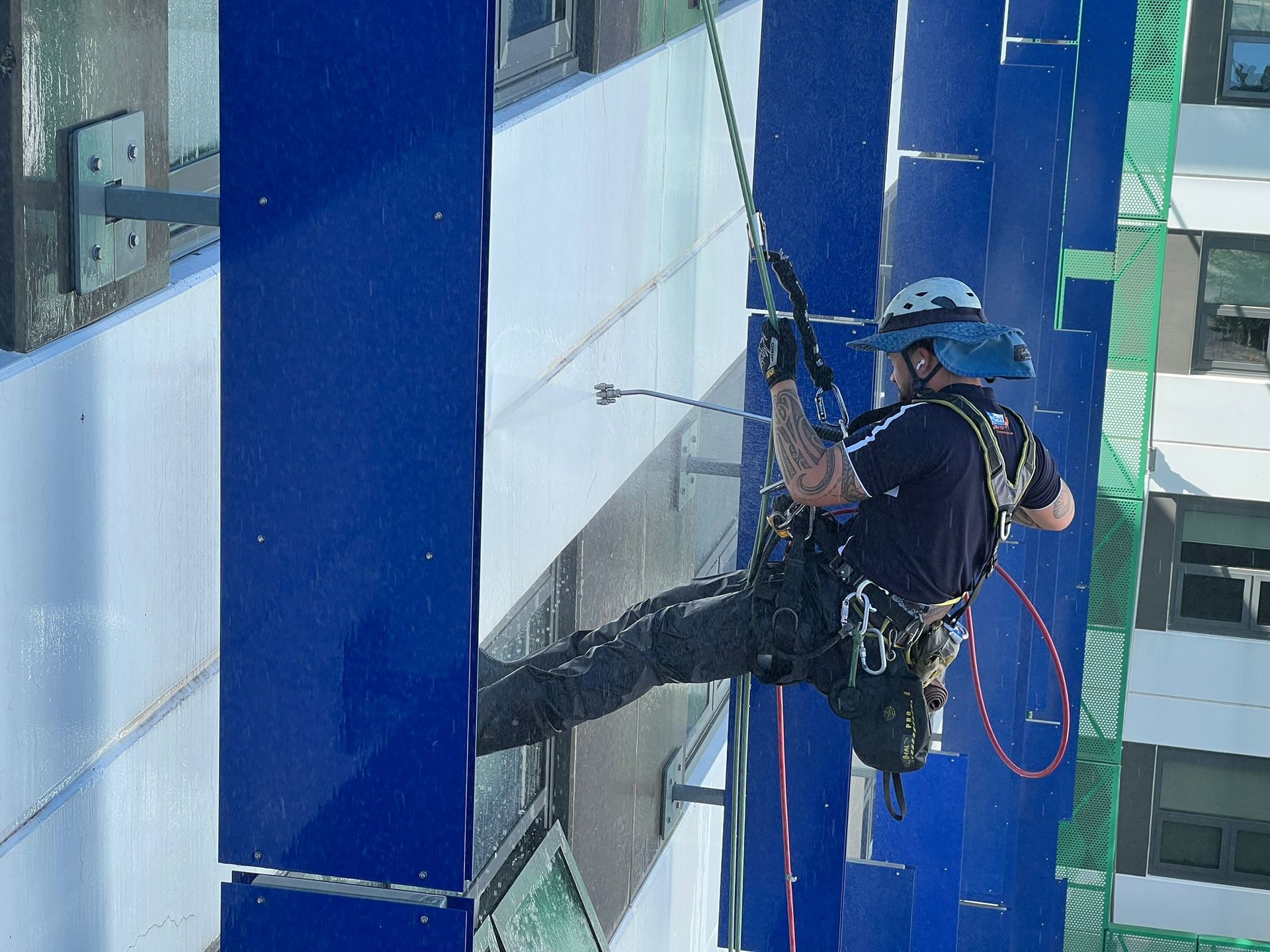 Man is Cleaning a Window on the Side of a Building — Capital Ultimate Facility in Beard, ACT