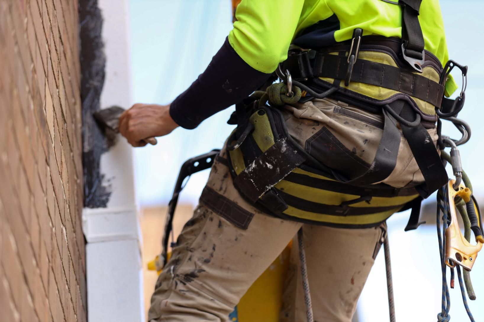 Man Wearing a Safety Harness is Painting a Wall — Capital Ultimate Facility in Beard, ACT