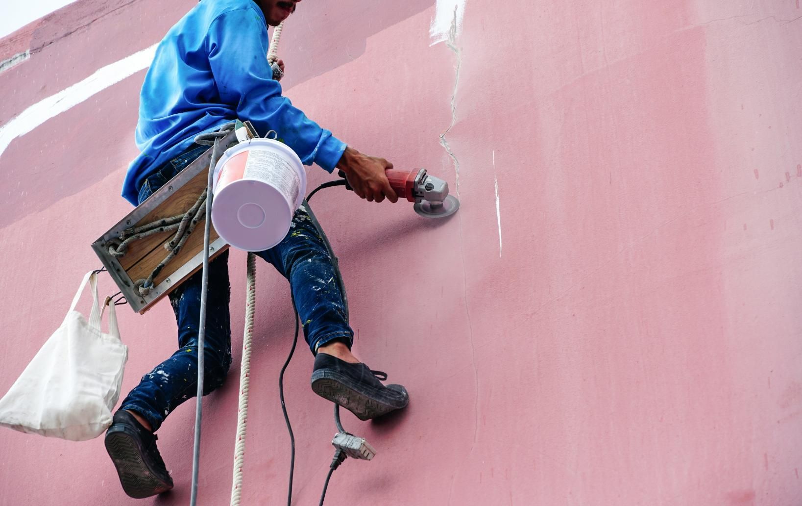 Man is Painting a Pink Wall With a Brush — Capital Ultimate Facility in Queanbeyan, NSW