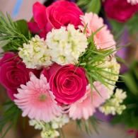 Pink and white flower bouquet with roses, daisies, and greenery