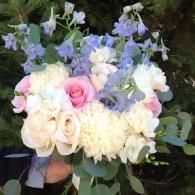 Pastel rose and hydrangea bouquet with white blooms and greenery outdoors