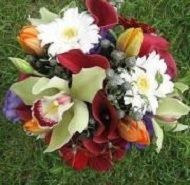 Colorful bouquet of mixed flowers with white, red, yellow, purple, and green blooms